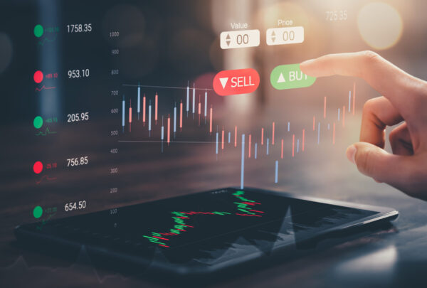 Stock exchange market concept, hand touching on trading icon screen with graphs analysis candle line on bokeh colors light.